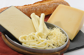 types of italian cheeses with bread on wooden cutting board